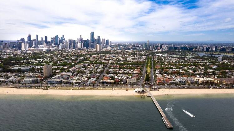 An aerial view of Melbourne from above Port Phillip Bay. 