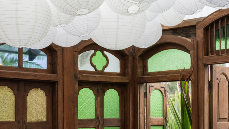 a restaurant with lanterns and stain-glass windows