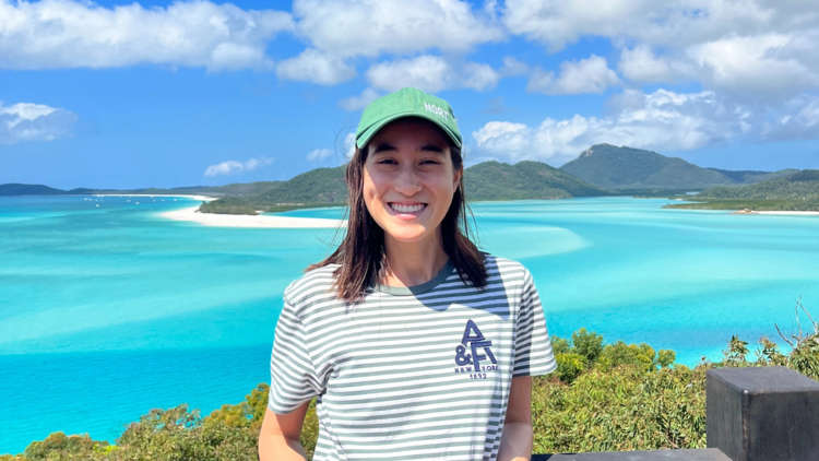 Girl smiling in front of beach lookout