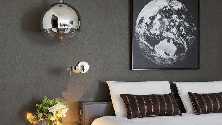 A close up of a hotel room with grey and silver accents. 