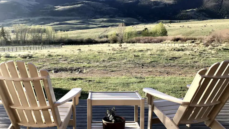 The cozy cabin surrounded by rolling foothills