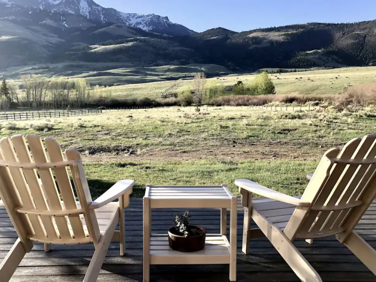 The cozy cabin surrounded by rolling foothills