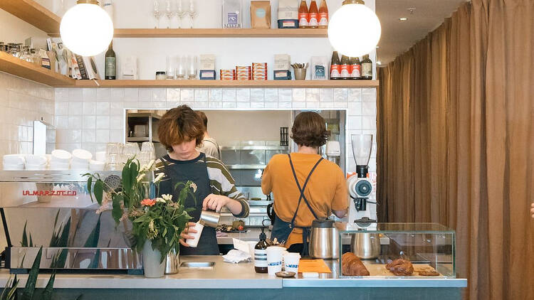 Staff working busily behind the bar at Lumen People.