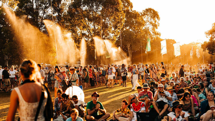 Festival ambience with people sitting on grass