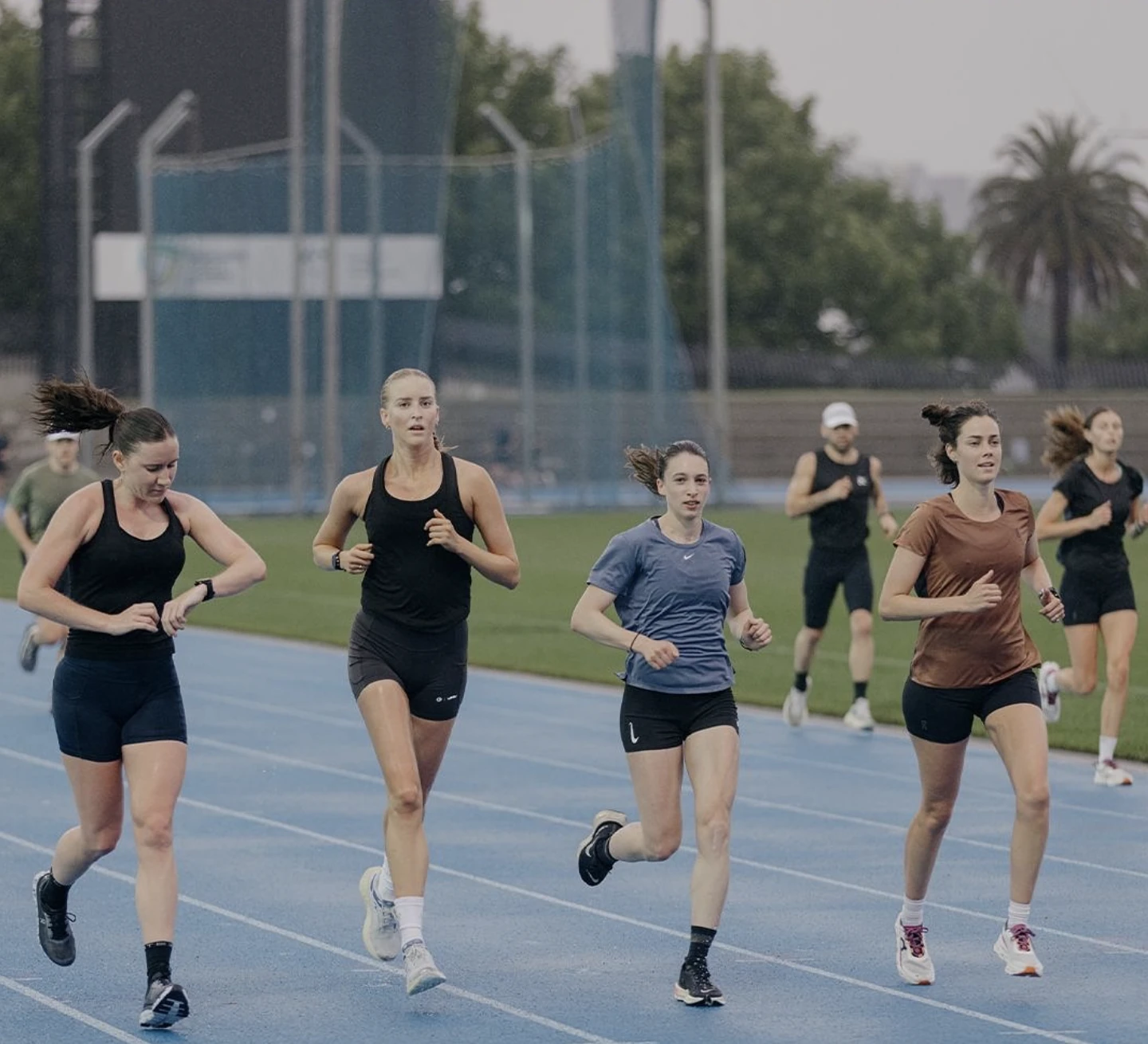 People running on an athletics track. 