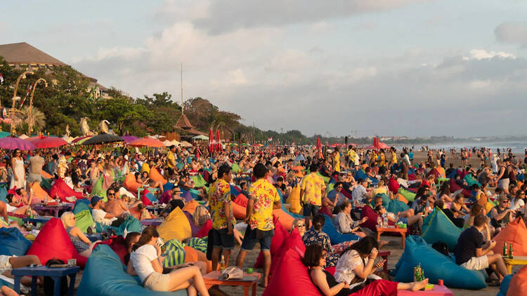 Large crowd of tourists on the beach in Seminyak, Indonesia