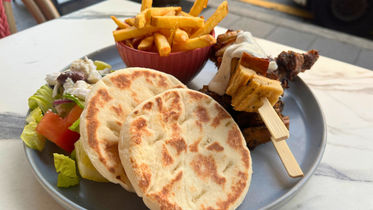 Souvlaki plate with pita, skewer, chips and salad