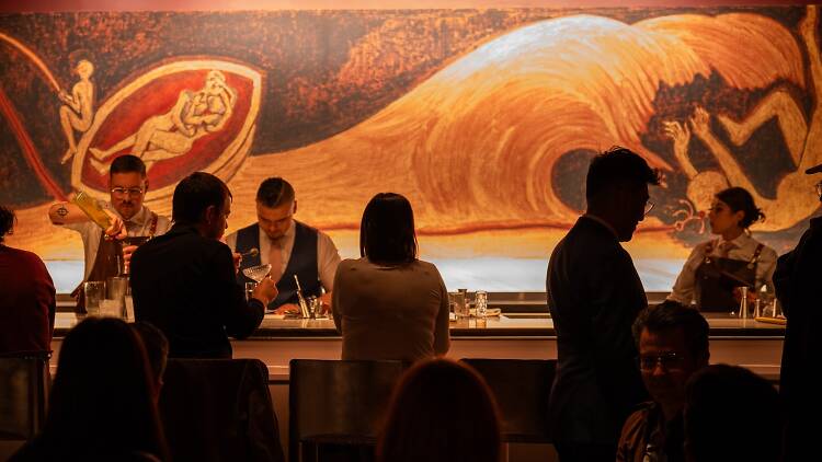 People sitting at the bar of Clemente Bar