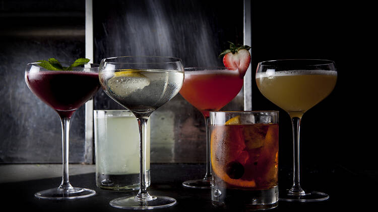 A line up of drinks against a black background