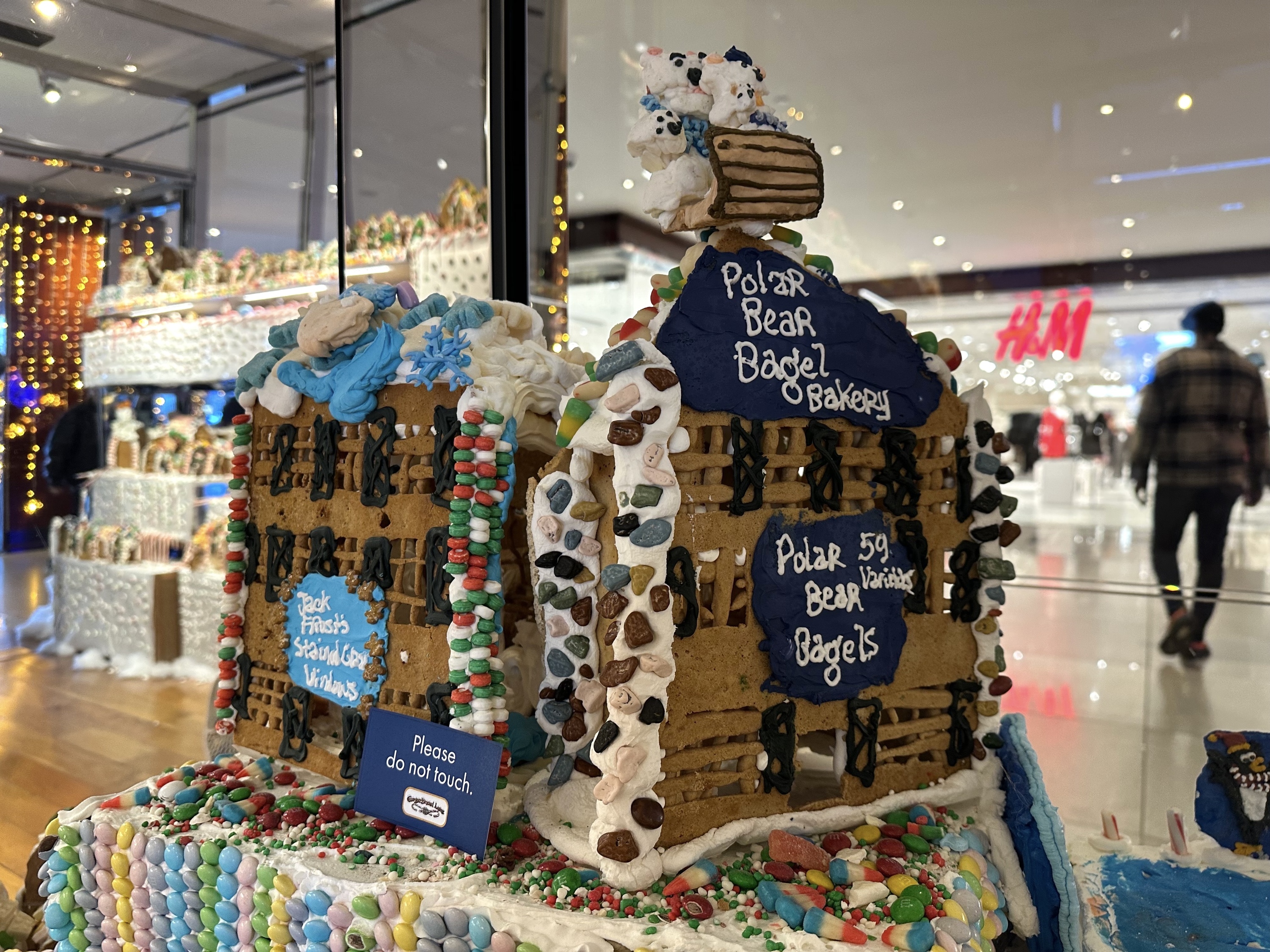 A close-up of a gingerbread structure reading Polar Bear Bagel Bakery.