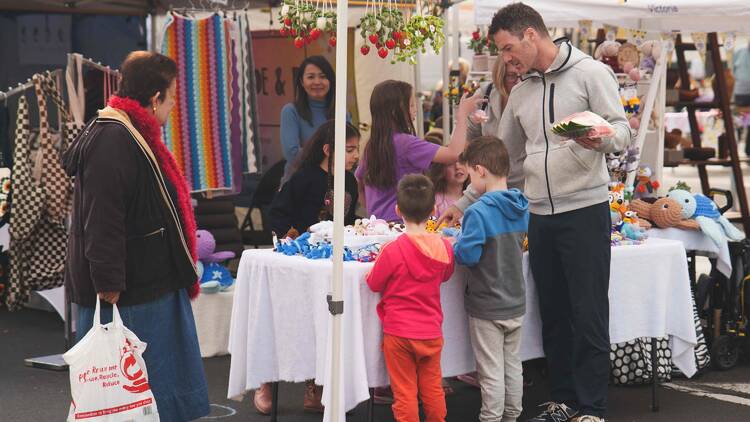 People browsing a market stall. 