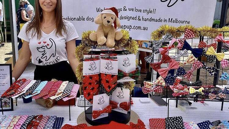 A stallholder with colourful dog accessories. 