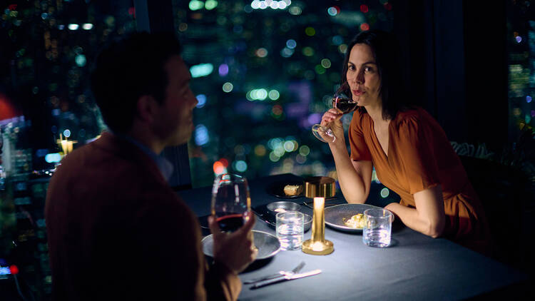 Two people dining at Eureka 89 at night.