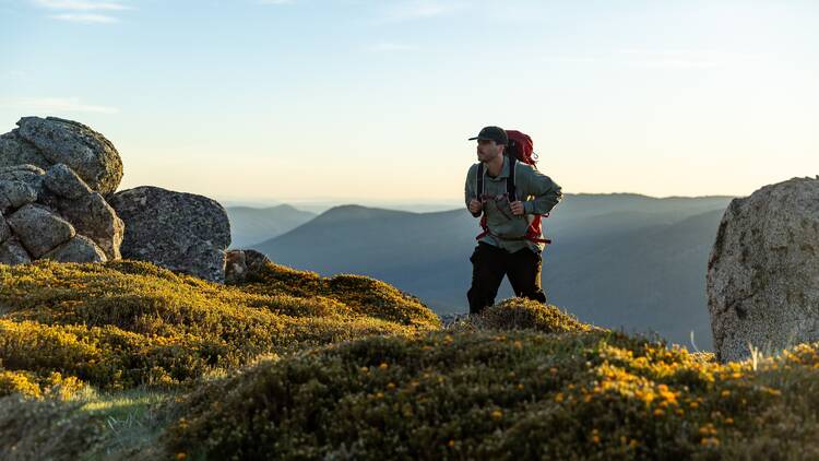 Hiker climbing mountain in Thredbo