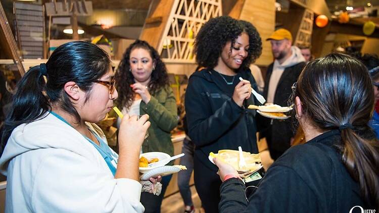 People eating dishes at an event