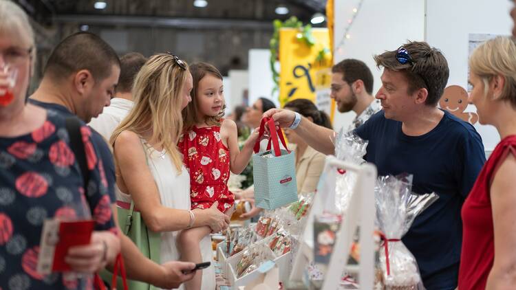 People shopping at a market stall. 