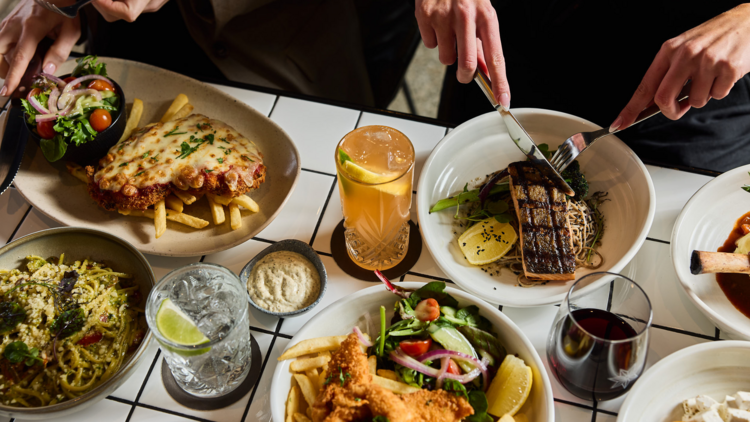 Pub spread of food on white tiled table