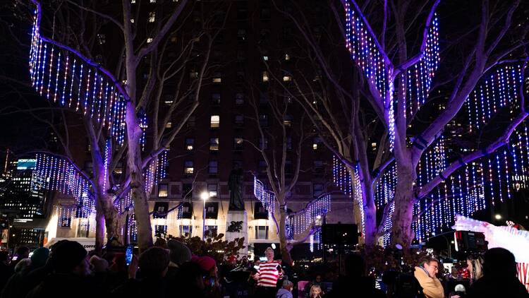 Trees illuminated with purple lights.