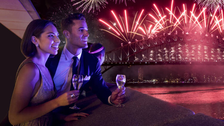 Two people watching the New Year's fireworks at Sydney Opera House