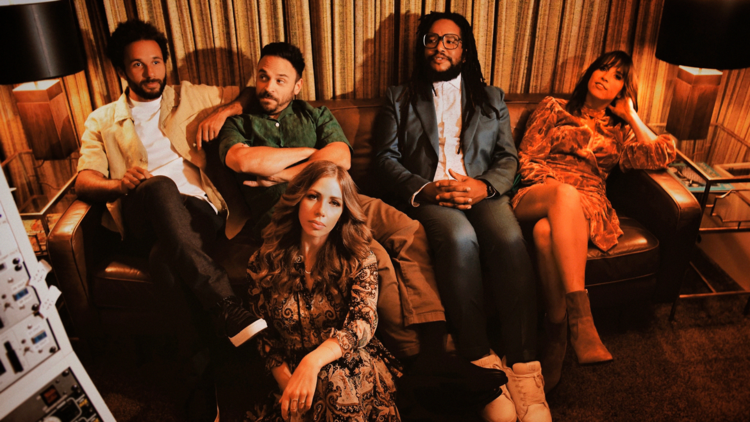 Members of Lake Street Dive on a couch