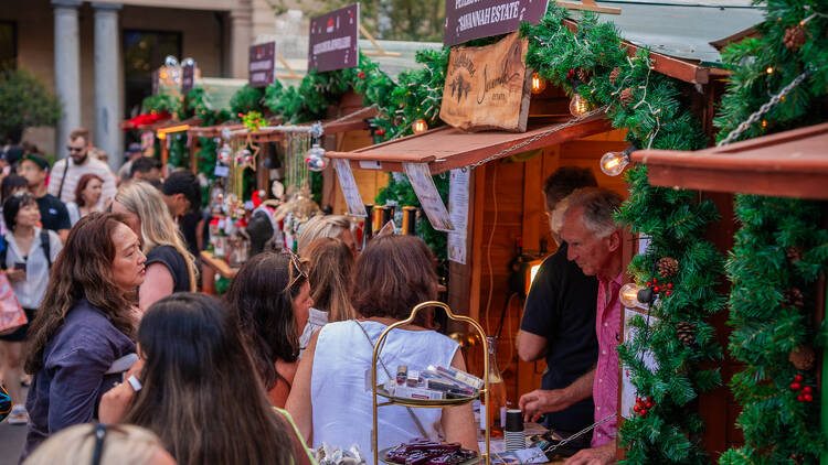 People lining up at market stalls 