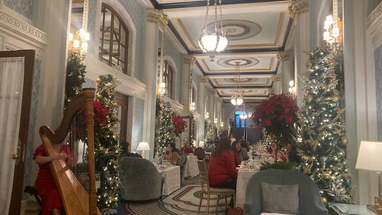 A festive scene inside holiday afternoon tea in Peacock Alley at The Willard in Washington, D.C.