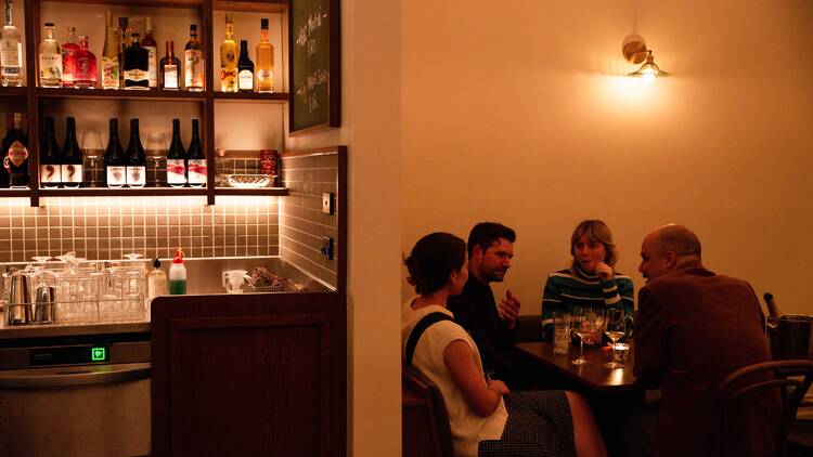 Group of friends sitting in a nook at Bar Bellamy.