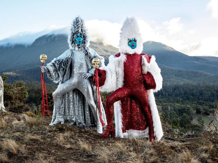 The Huxleys posing in extravagant costumes on mountain 