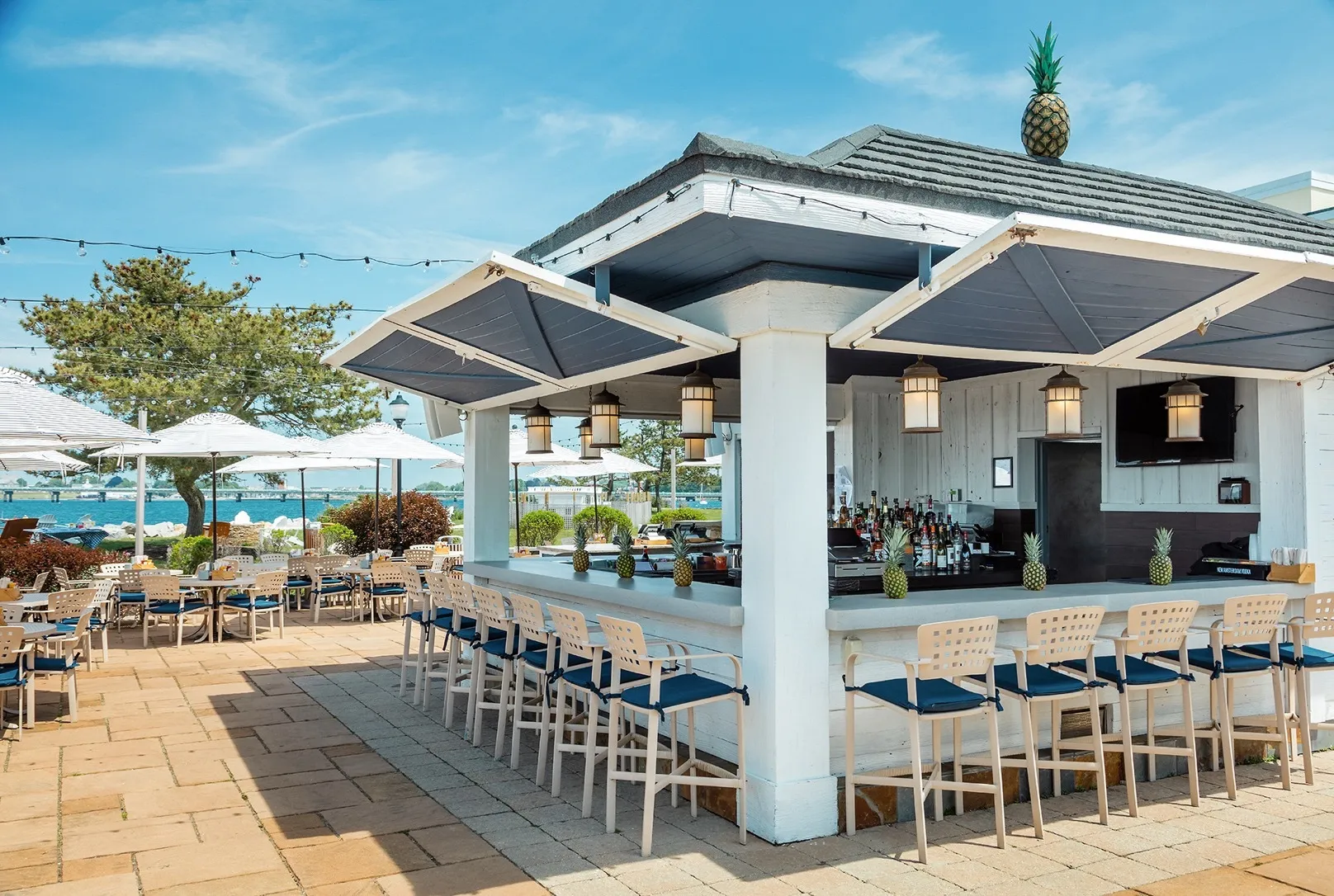 An outdoor patio with a bar and lounge areas.