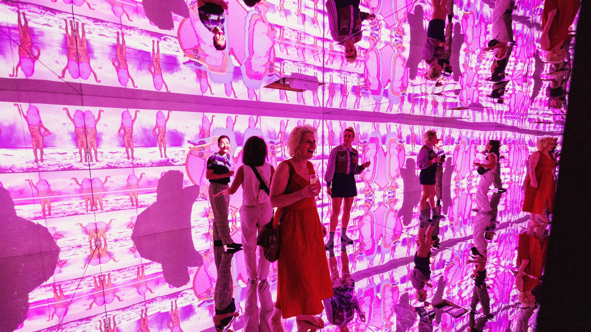 People stand in a room with projections