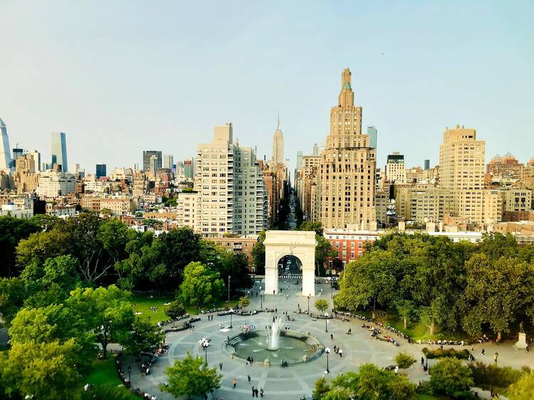 Washington Square Park with its fountain, arch, and skyline behind it.