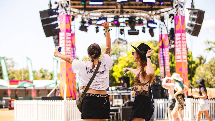 Two girls dancing at music festival