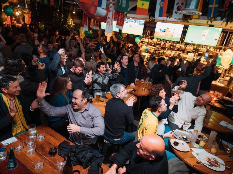 Crowded pub with live sport on television