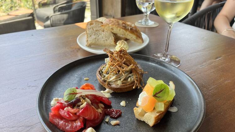 Trio of entrees on black plate