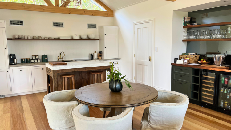 Bright dining room with kitchen and table