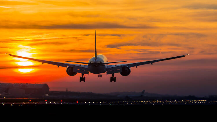 Flight landing at London Heathrow at sunset