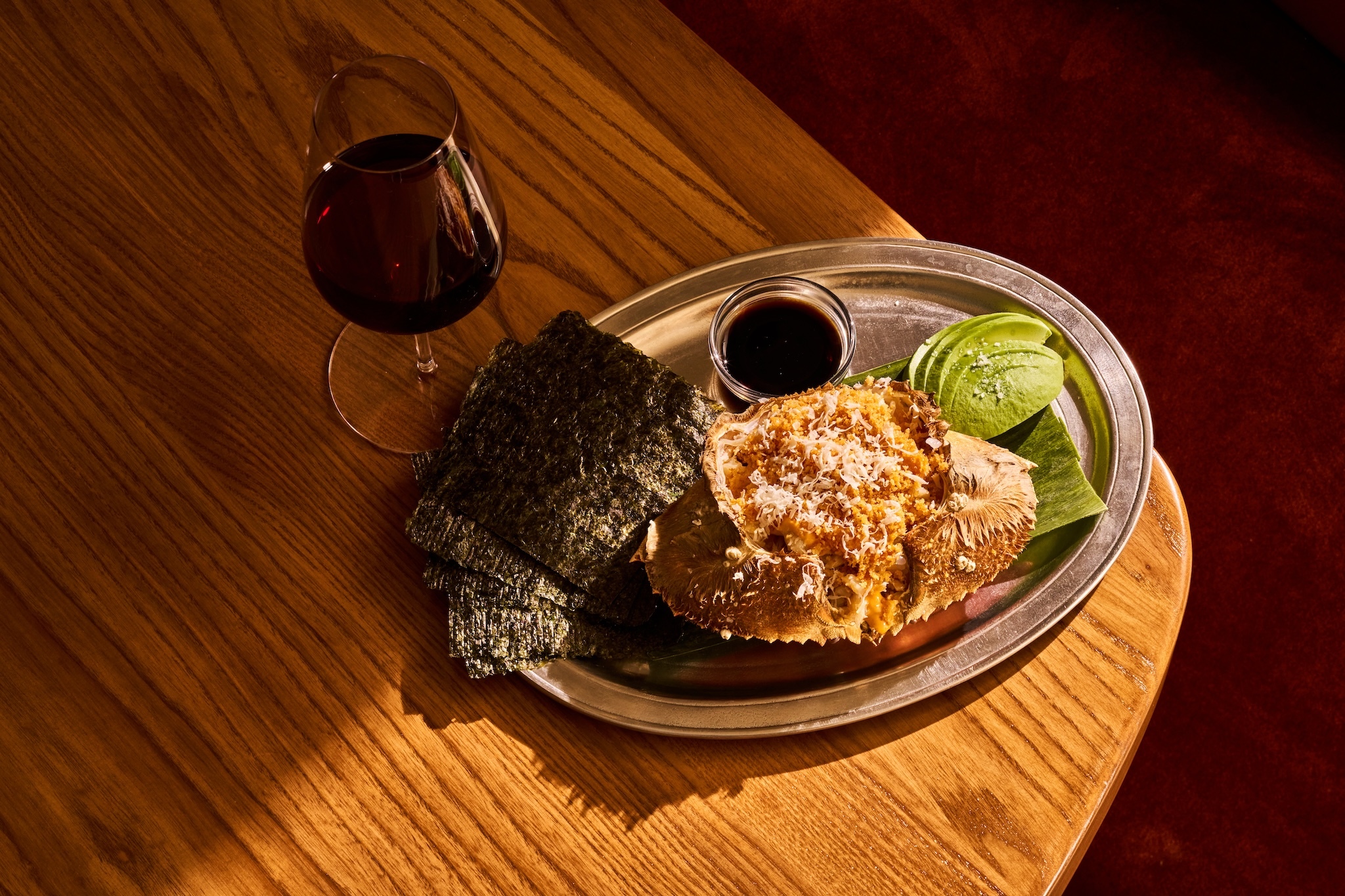 The Dungness Crab on a table with a glass of red wine