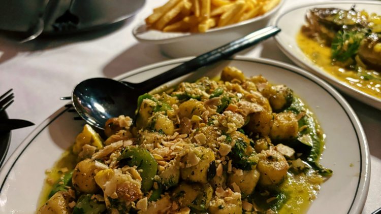 Plates of gnocchi and fries.