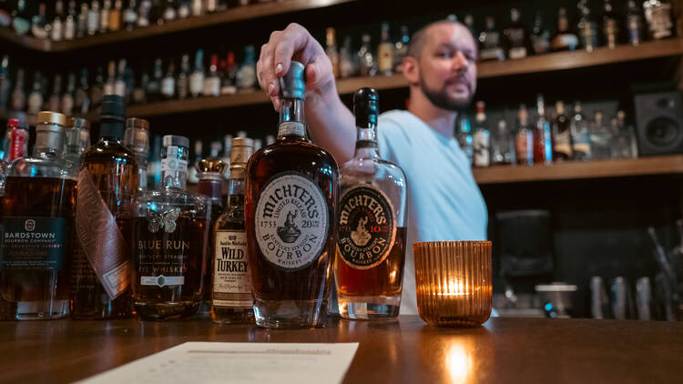 Bartender serving up bourbon.