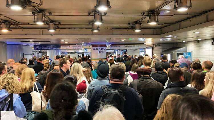 Commuters queuing at a London tube station