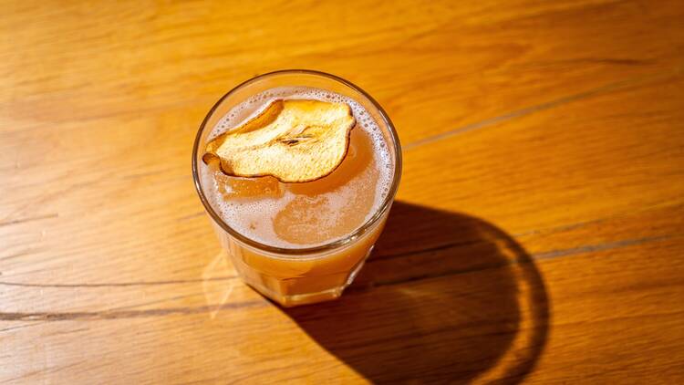 A bourbon based cocktail with a dehydrated pear