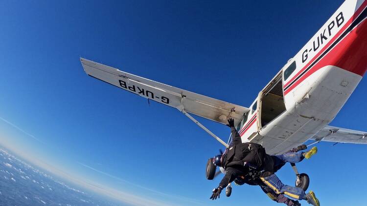 Someone jumping out of a plane