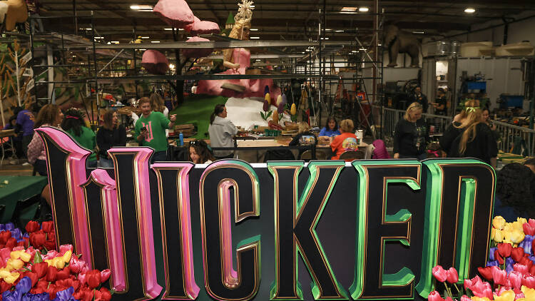 A team building the Wicked “Defying Gravity” Rose Parade float.