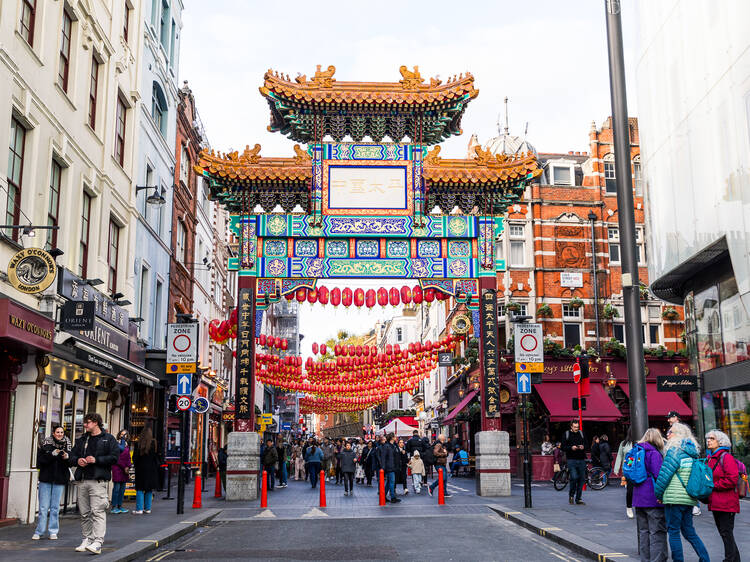 Chinatown’s ornately decorated archway known as the Chinatown Gate, with strings of red and gold paper lanterns in the background