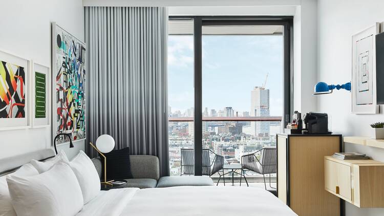 A hotel room with views of the NYC skyline.