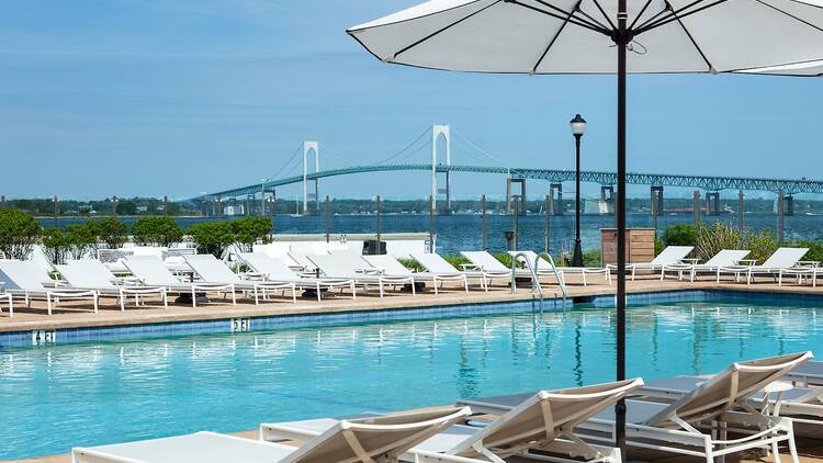 A pool with reclining lounge chairs.