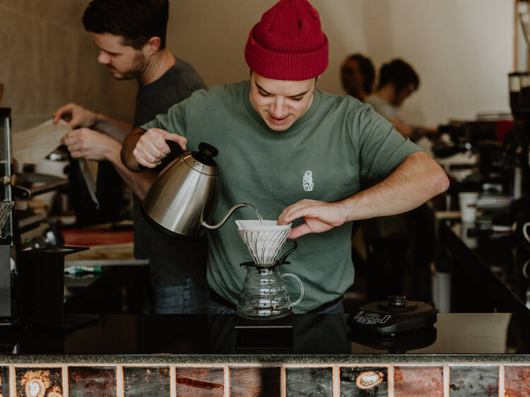 Barista making filter coffee