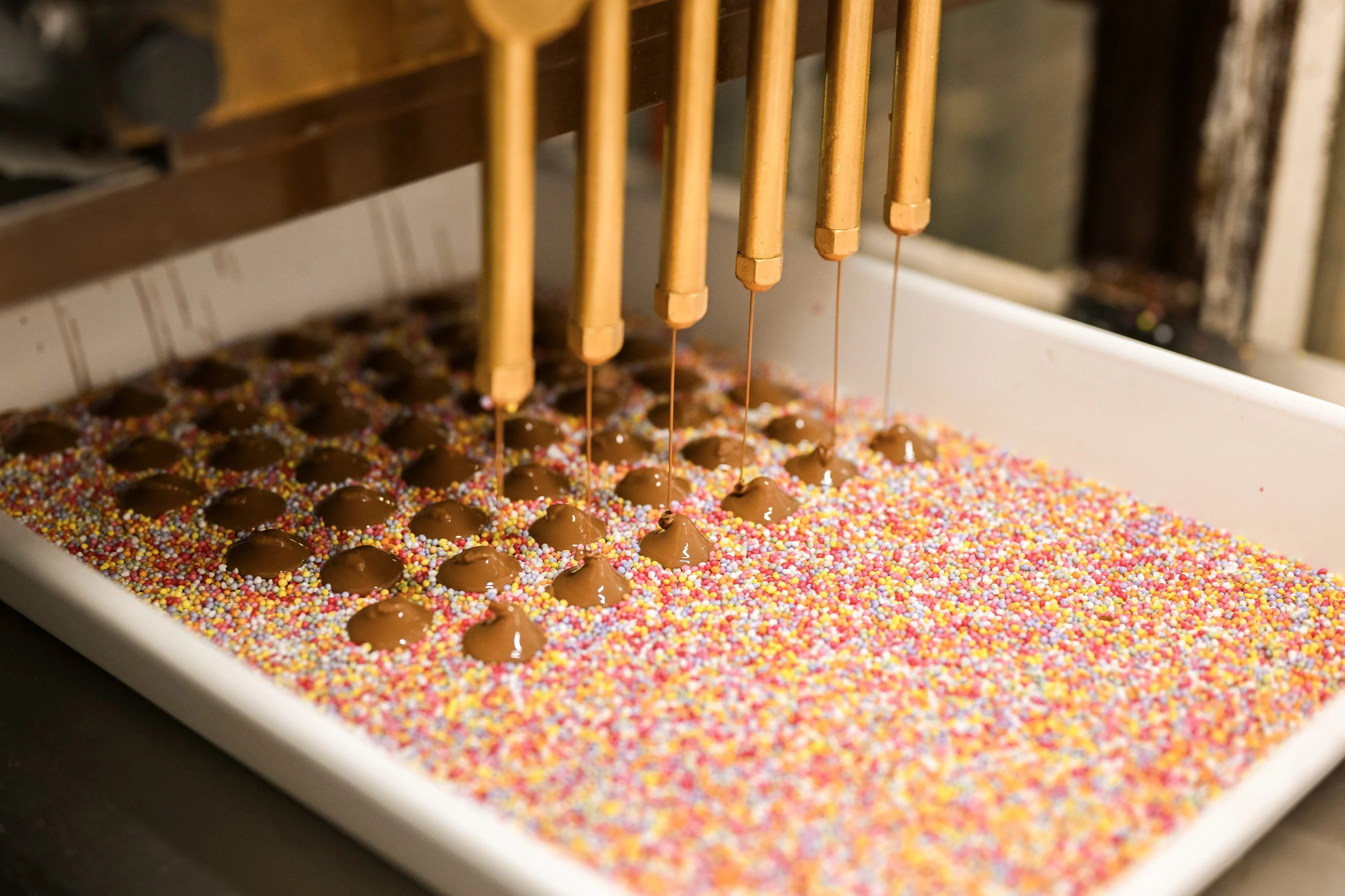 Freckle chocolate being coated