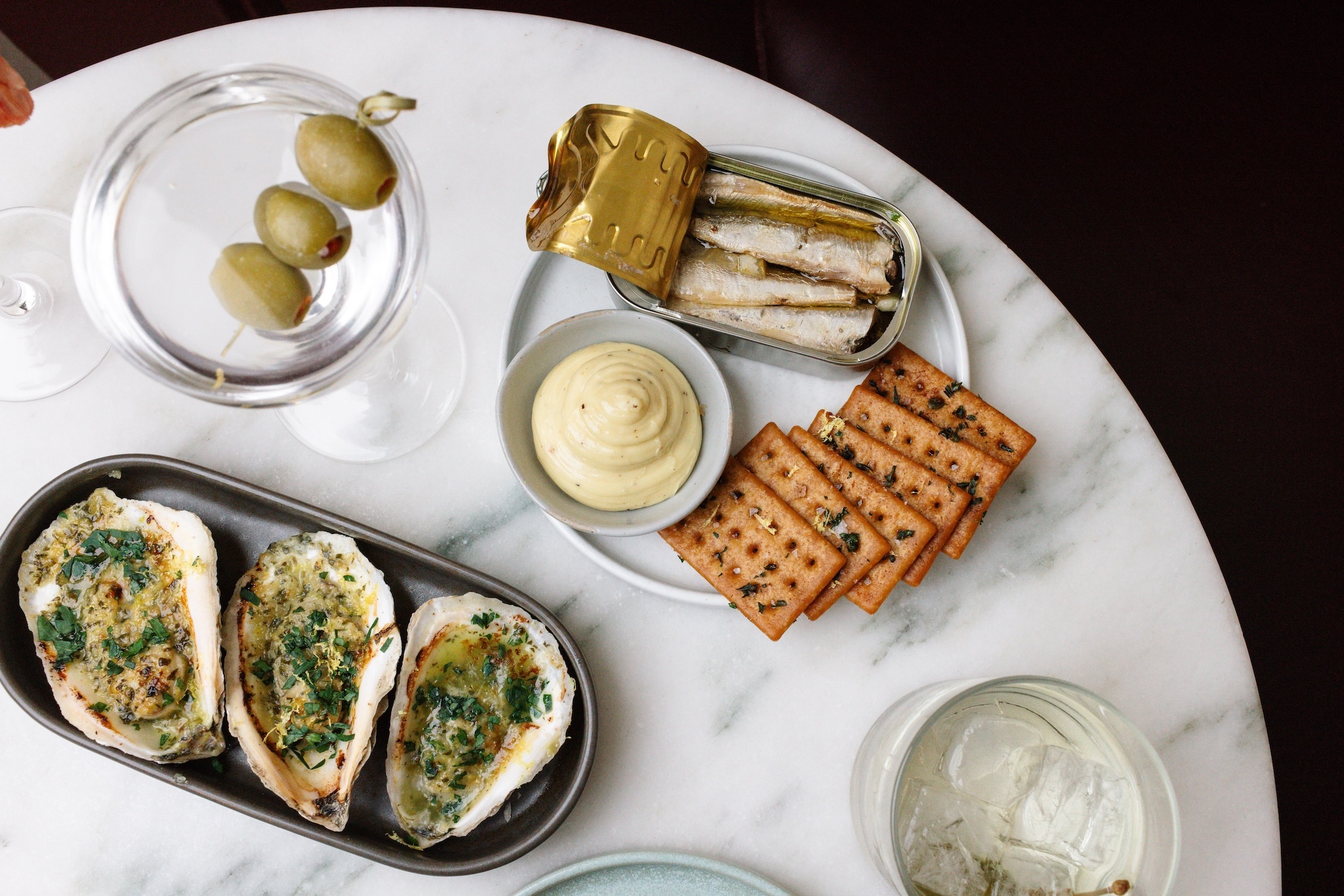 A table of oysters and tinned fish