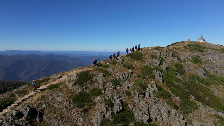 People climbing a mountain ridge